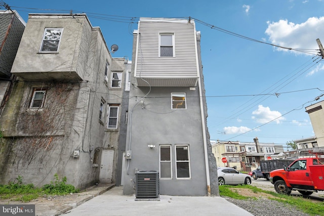 1419 S 56th St, Philadelphia, PA 19143 - rear view of house featuring central air condition unit and stucco siding