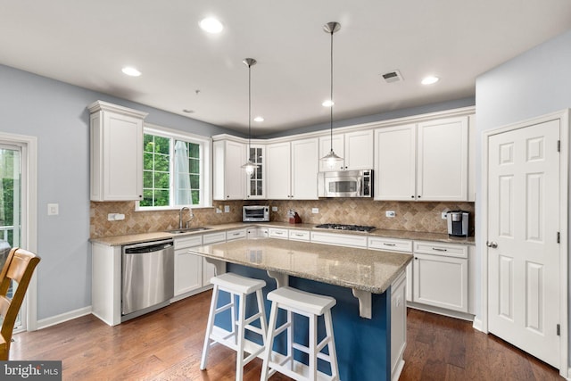 1509 Blakes Legacy Dr, Bel Air, MD 21014 - kitchen with appliances with stainless steel finishes, white cabinets, dark wood-style floors, decorative backsplash, and recessed lighting