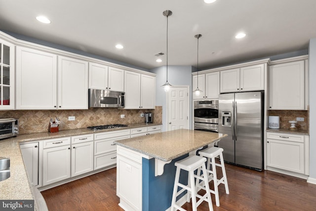 1509 Blakes Legacy Dr, Bel Air, MD 21014 - kitchen featuring stainless steel appliances, decorative backsplash, white cabinets, a center island, and recessed lighting
