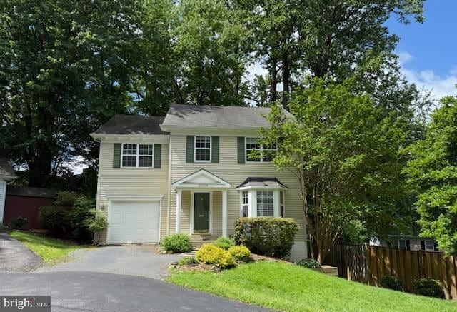 10024 Park Woods Ln, Burke, VA 22015 - colonial house featuring asphalt driveway and an attached garage