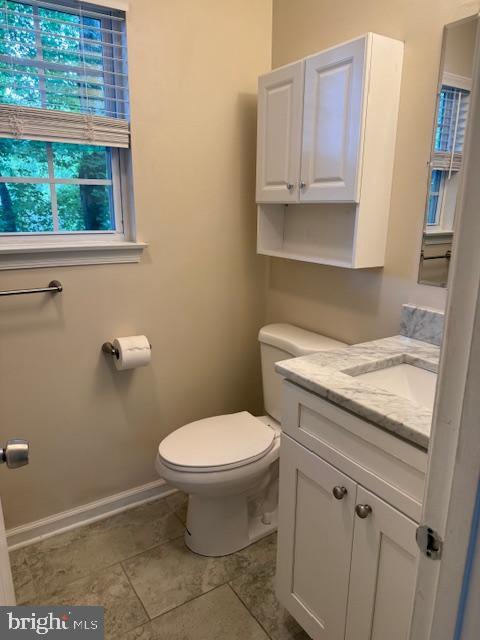 10024 Park Woods Ln, Burke, VA 22015 - bathroom with vanity, toilet, baseboards, and tile patterned floors