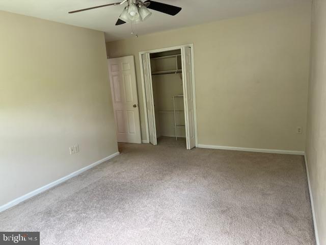 10024 Park Woods Ln, Burke, VA 22015 - unfurnished bedroom with carpet floors, a closet, baseboards, and ceiling fan