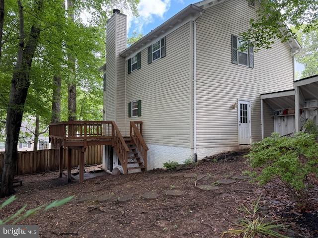 10024 Park Woods Ln, Burke, VA 22015 - back of property featuring stairway, a wooden deck, and a chimney