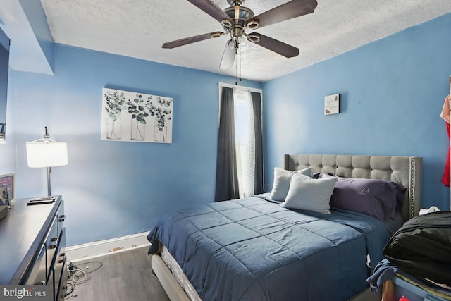 2530 Arunah Ave, Baltimore, MD 21216 - bedroom with wood finished floors, baseboards, a textured ceiling, and a ceiling fan
