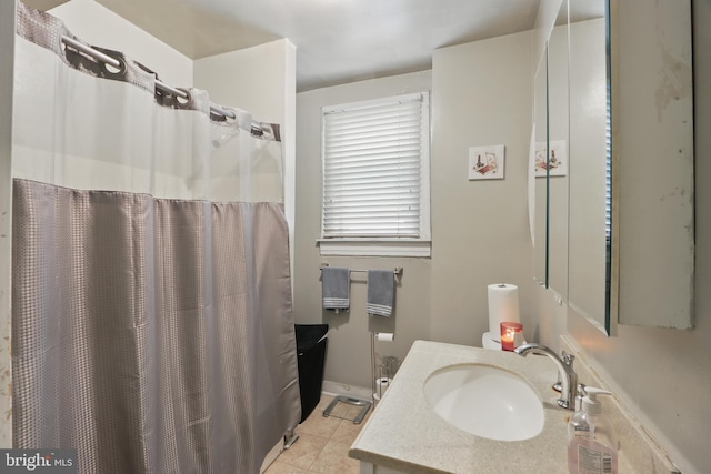2530 Arunah Ave, Baltimore, MD 21216 - full bath with vanity, tile patterned flooring, a shower with curtain, and baseboards