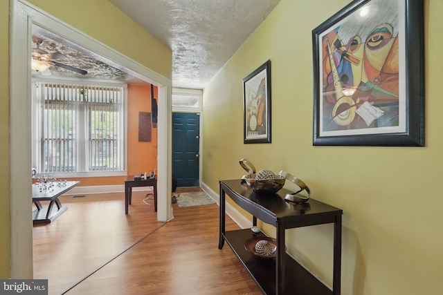 2530 Arunah Ave, Baltimore, MD 21216 - hall featuring wood finished floors, a textured ceiling, and baseboards