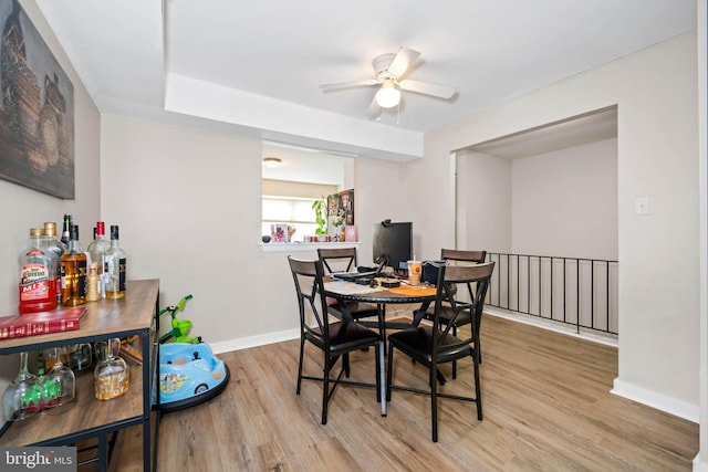 1210 Chelmsford Cir Unit 1210, Newark, DE 19713 - dining space with wood finished floors, baseboards, a ceiling fan, and a bar