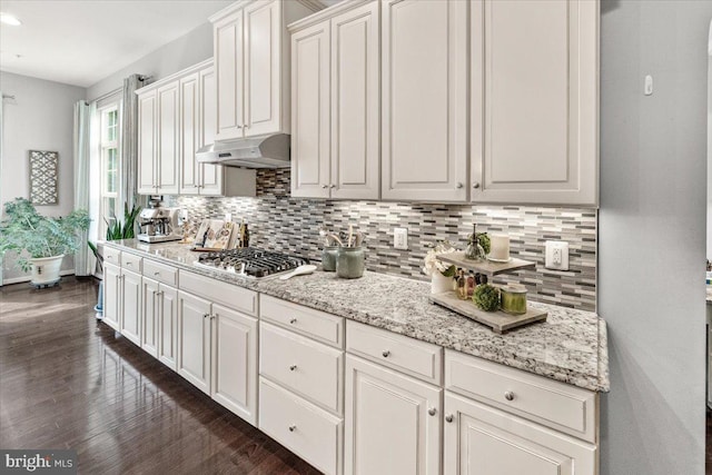 6808 Rehnquist Ct, New Market, MD 21774 - kitchen featuring stainless steel gas stovetop, tasteful backsplash, dark wood-style flooring, under cabinet range hood, and white cabinetry