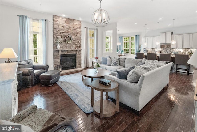 6808 Rehnquist Ct, New Market, MD 21774 - living area featuring dark wood-type flooring, a chandelier, recessed lighting, and a fireplace