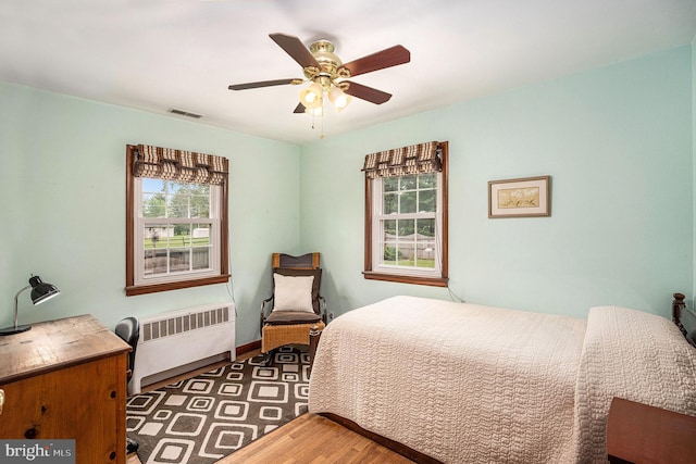 787 Park Rd, Lansdale, PA 19446 - bedroom featuring radiator heating unit, wood finished floors, and a ceiling fan