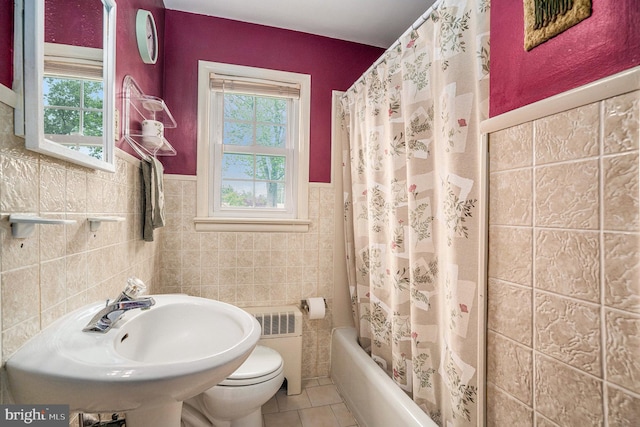 787 Park Rd, Lansdale, PA 19446 - bathroom featuring tile walls, radiator heating unit, tile patterned floors, shower / tub combo, and a wainscoted wall
