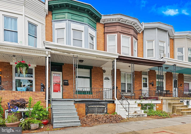 4106 Falls Rd, Baltimore, MD 21211 - multi unit property featuring a porch, brick siding, and cooling unit