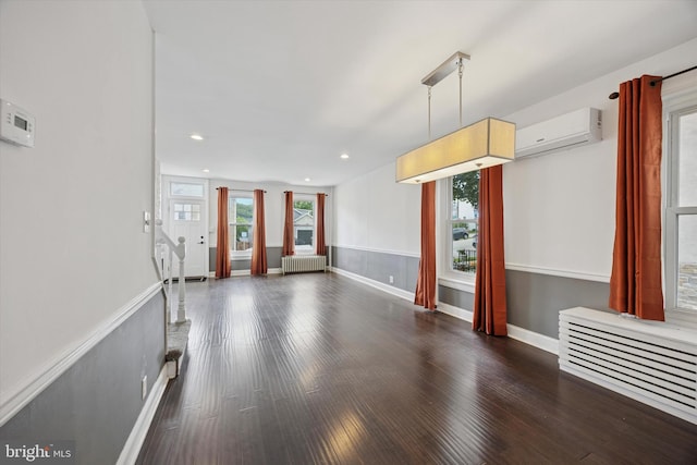 534 Spring Mill Ave, Conshohocken, PA 19428 - unfurnished living room featuring radiator, a wall mounted air conditioner, wood finished floors, baseboards, and recessed lighting
