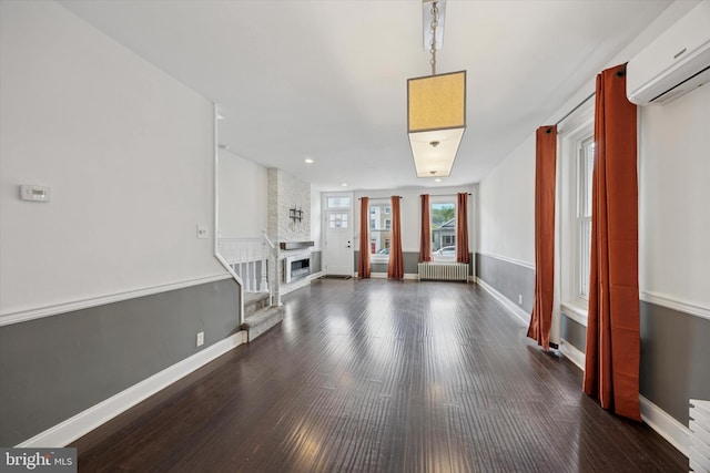 534 Spring Mill Ave, Conshohocken, PA 19428 - unfurnished living room with a wall mounted AC, radiator, baseboards, wood finished floors, and recessed lighting