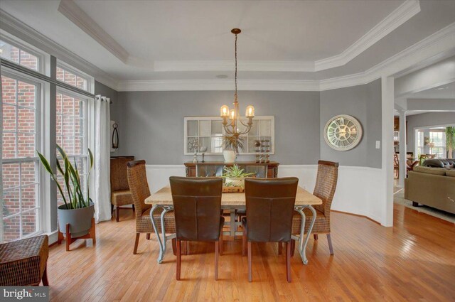 11516 Mystic Rock Ln N, Waynesboro, PA 17268 - dining room with a raised ceiling, crown molding, light wood-type flooring, wainscoting, and a chandelier