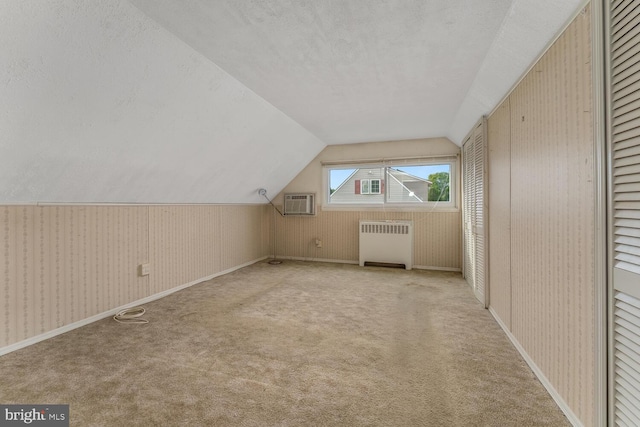 54 Cobalt Ridge Dr E, Levittown, PA 19057 - bonus room featuring radiator heating unit, a textured ceiling, lofted ceiling, carpet floors, and a wall mounted air conditioner