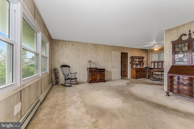 54 Cobalt Ridge Dr E, Levittown, PA 19057 - living area with carpet, a baseboard heating unit, ceiling fan, and wood walls