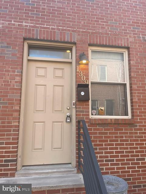 1309 S Chadwick St, Philadelphia, PA 19146 - view of exterior entry featuring brick siding