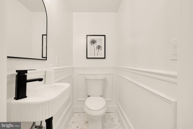 4308 4th St NW, Washington, DC 20011 - bathroom with toilet, a decorative wall, wainscoting, and a sink
