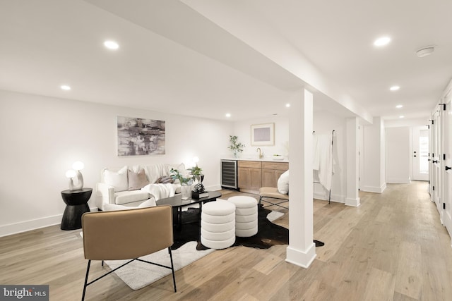 4308 4th St NW, Washington, DC 20011 - living room featuring wine cooler, light wood finished floors, bar with sink, baseboards, and recessed lighting