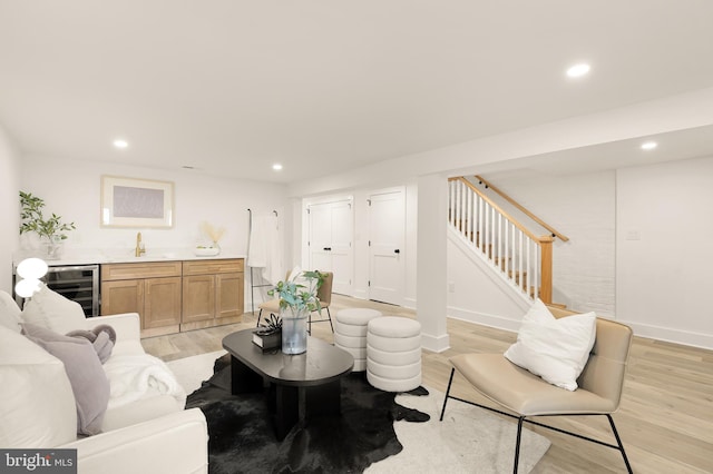 4308 4th St NW, Washington, DC 20011 - living room with beverage cooler, bar with sink, light wood-type flooring, recessed lighting, and stairs