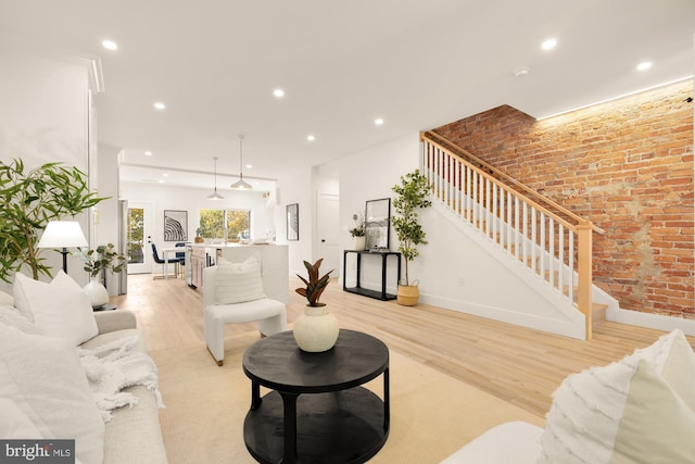 4308 4th St NW, Washington, DC 20011 - living room featuring stairway, recessed lighting, light wood-style flooring, baseboards, and brick wall