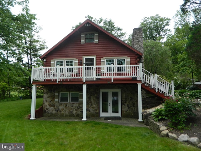 126 Ivy Ln, Lock Haven, PA 17745 - back of property featuring a wooden deck, log exterior, a lawn, a chimney, and stone siding