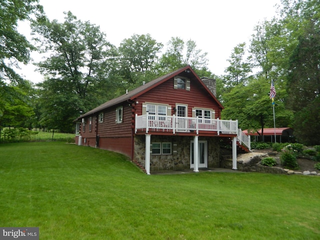 126 Ivy Ln, Lock Haven, PA 17745 - rear view of house with log exterior, a deck, a lawn, stone siding, and a chimney