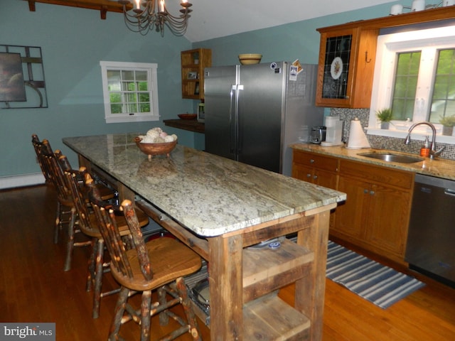 126 Ivy Ln, Lock Haven, PA 17745 - kitchen featuring appliances with stainless steel finishes, brown cabinets, a sink, dark wood-style floors, and a chandelier