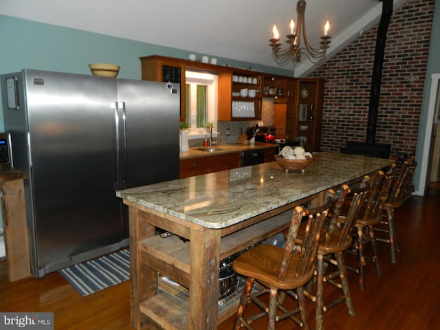 126 Ivy Ln, Lock Haven, PA 17745 - kitchen featuring freestanding refrigerator, dark wood-style flooring, vaulted ceiling, a chandelier, and brown cabinetry