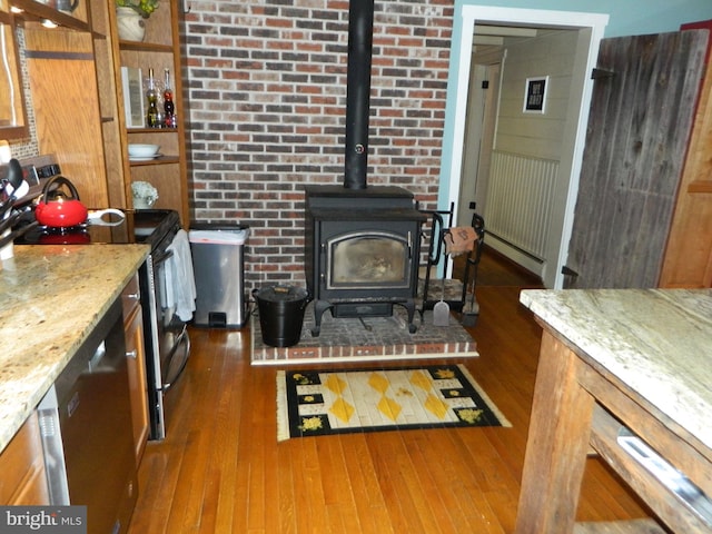 126 Ivy Ln, Lock Haven, PA 17745 - living area with dark wood-type flooring, a wood stove, and a baseboard radiator
