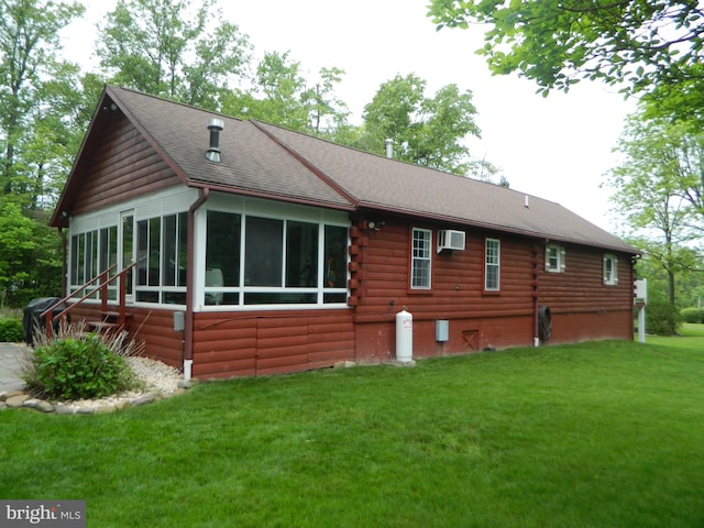 126 Ivy Ln, Lock Haven, PA 17745 - back of property with an AC wall unit, log exterior, a lawn, a sunroom, and roof with shingles