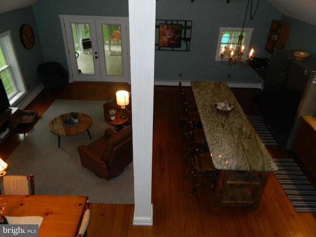 126 Ivy Ln, Lock Haven, PA 17745 - living area with wood finished floors, decorative columns, a chandelier, and lofted ceiling