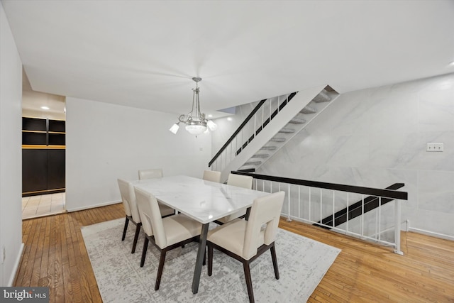 137 N 22nd St, Philadelphia, PA 19103 - dining area featuring stairway, hardwood / wood-style floors, and a chandelier