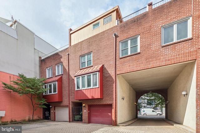 137 N 22nd St, Philadelphia, PA 19103 - view of building exterior with an attached garage and driveway