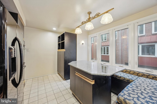 137 N 22nd St, Philadelphia, PA 19103 - kitchen with stainless steel fridge with ice dispenser, light tile patterned flooring, light stone counters, decorative light fixtures, and recessed lighting