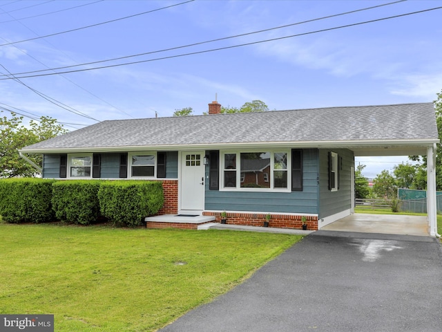 103 Plainfield Dr, Winchester, VA 22602 - view of front of house featuring asphalt driveway, a chimney, an attached carport, and a shingled roof