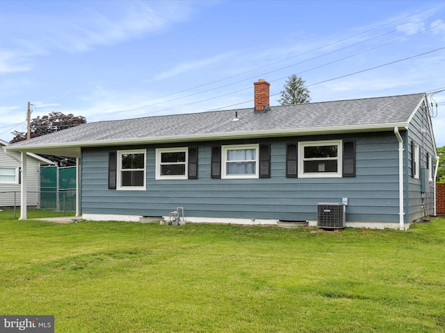 103 Plainfield Dr, Winchester, VA 22602 - back of property with central air condition unit, a lawn, a chimney, and roof with shingles
