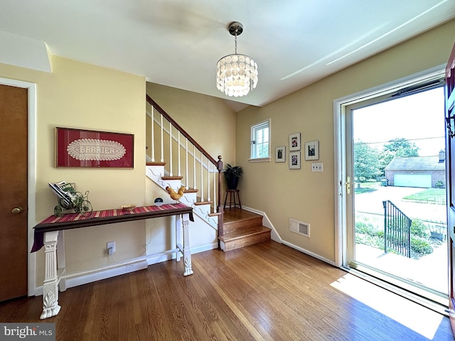 113 Sypherd Dr, Newark, DE 19711 - foyer entrance with a chandelier, wood finished floors, stairway, and baseboards