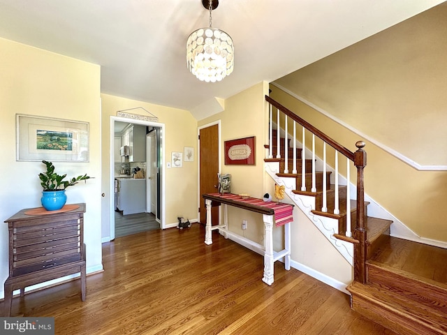 113 Sypherd Dr, Newark, DE 19711 - stairway with wood finished floors, a chandelier, and baseboards