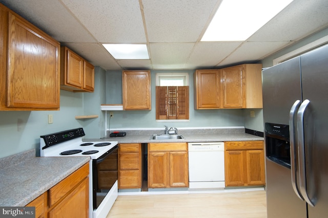 217 W End Ave, Cambridge, MD 21613 - kitchen with white appliances, a sink, a paneled ceiling, light countertops, and brown cabinets