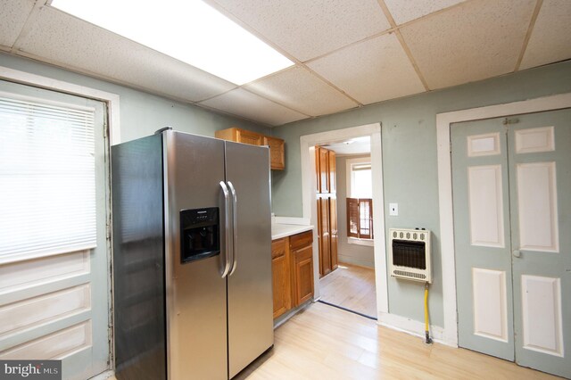217 W End Ave, Cambridge, MD 21613 - kitchen with stainless steel fridge with ice dispenser, heating unit, a paneled ceiling, brown cabinetry, and light wood finished floors