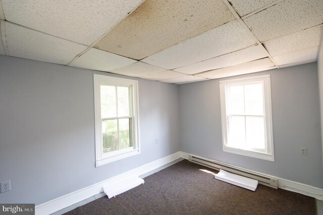 217 W End Ave, Cambridge, MD 21613 - spare room with a baseboard radiator, a drop ceiling, baseboards, and dark carpet