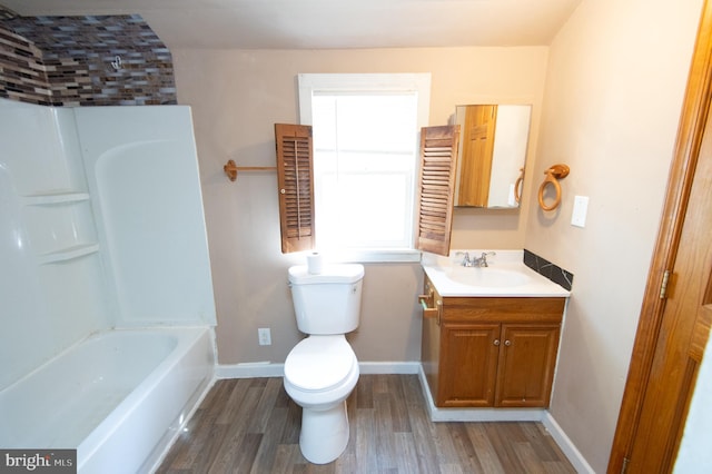 217 W End Ave, Cambridge, MD 21613 - bathroom with vanity, wood finished floors, toilet, baseboards, and washtub / shower combination