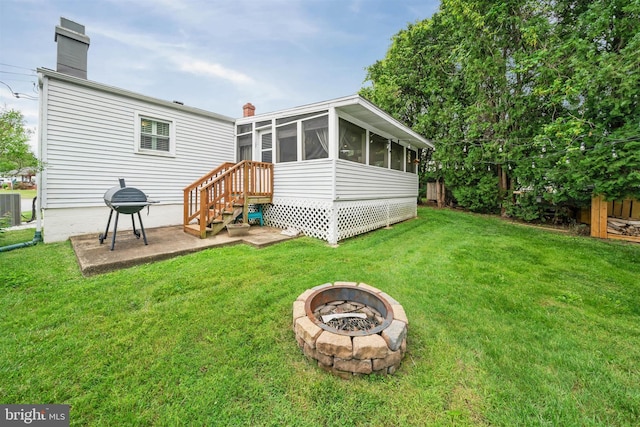 128 Durso Dr, Newark, DE 19711 - back of property with a fire pit, a sunroom, a chimney, and a lawn