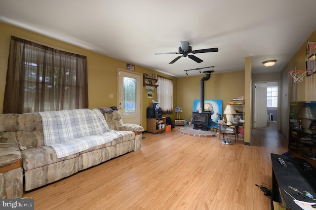 224 W Underwood Ave, West Deptford, NJ 08096 - living area with wood finished floors, a wood stove, and ceiling fan
