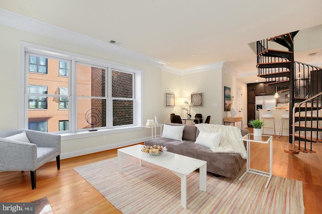 1323 Clifton St NW Unit 34, Washington, DC 20009 - living area with stairs, crown molding, light wood-style floors, and baseboards