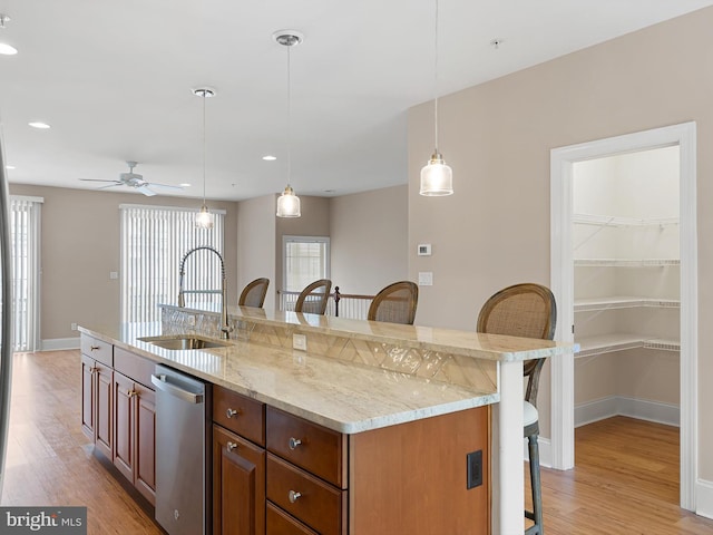 105 Sutton Way, Newark, DE 19711 - kitchen with dishwasher, a breakfast bar, a sink, light wood-style floors, and recessed lighting