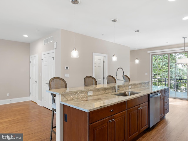 105 Sutton Way, Newark, DE 19711 - kitchen with dishwasher, a sink, a kitchen breakfast bar, light wood finished floors, and recessed lighting
