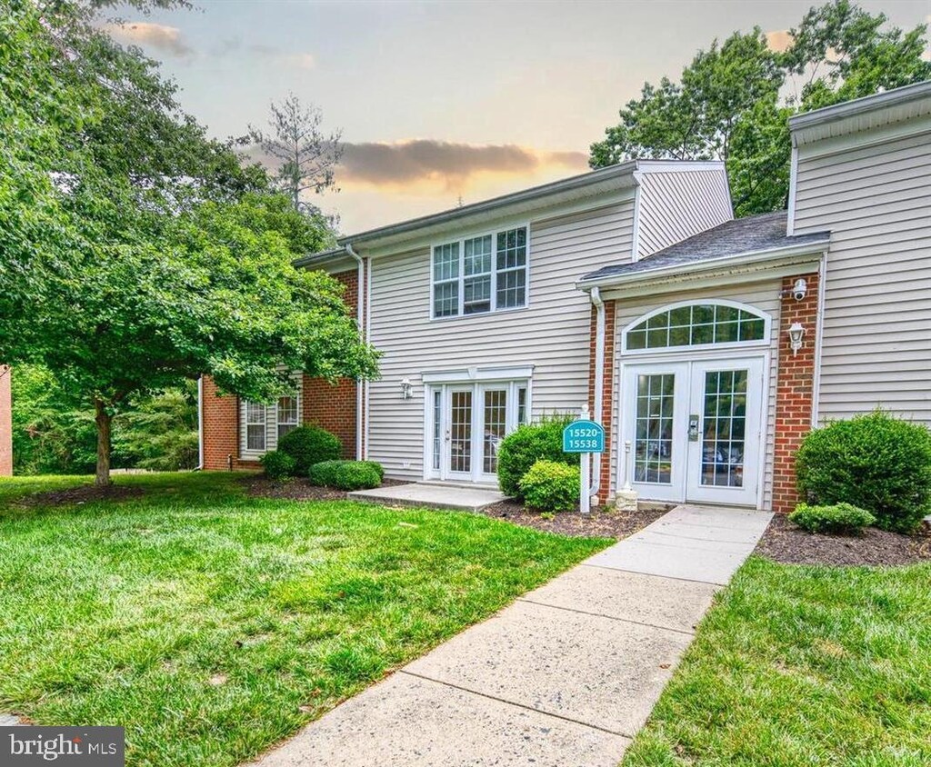 15524 Horseshoe Ln, Woodbridge, VA 22191 - view of front facade with french doors, a yard, and brick siding